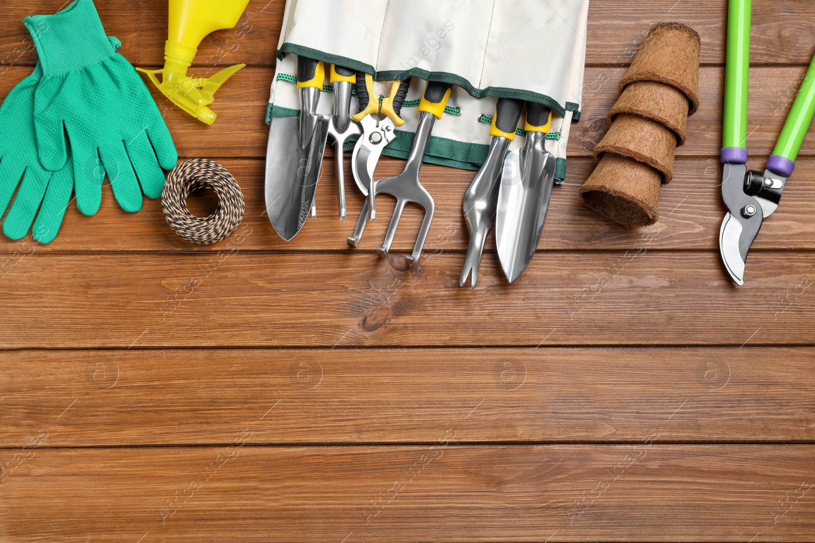 Photo of Flat lay composition with gardening tools on wooden background, space for text