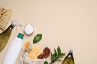 Photo of Flat lay composition with different cleaning supplies on beige background. Space for text