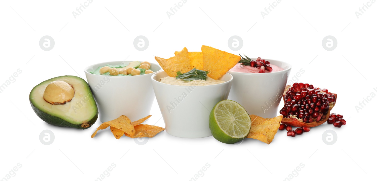 Photo of Different kinds of tasty hummus, nachos and ingredients on white background