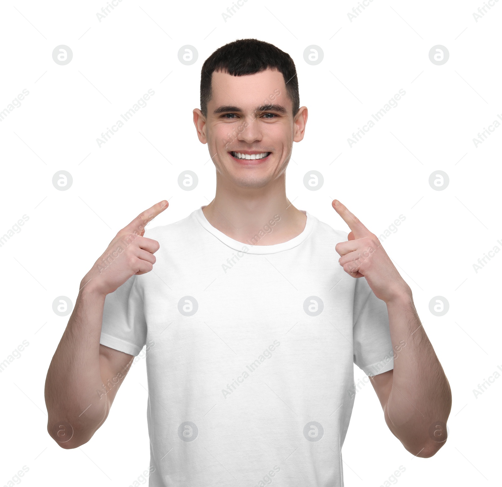 Photo of Handsome young man showing his clean teeth on white background