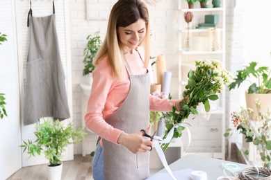 Female florist creating bouquet at workplace