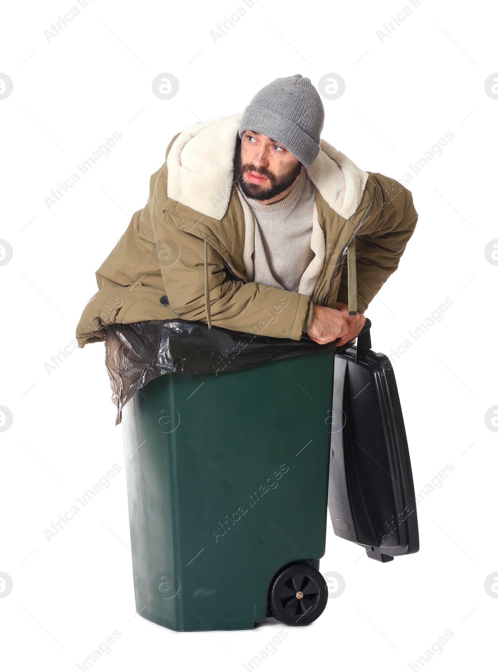 Photo of Poor homeless man in trash bin isolated on white