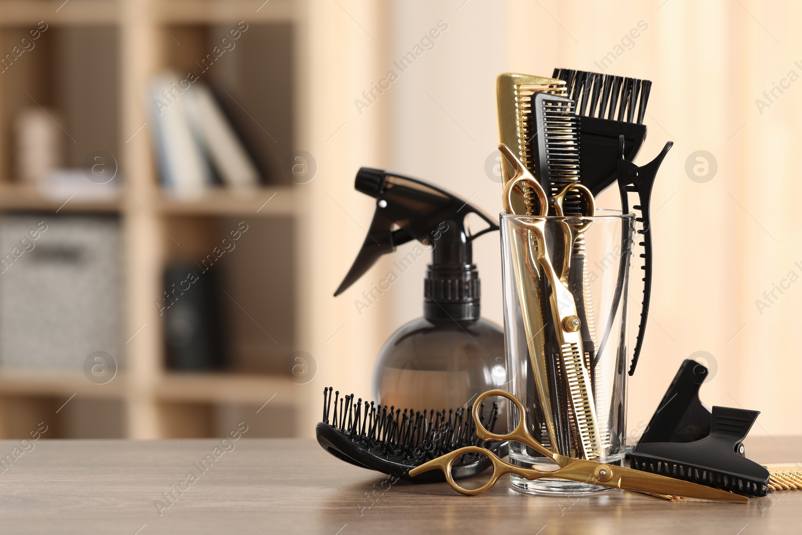 Photo of Set of hairdresser tools on table in salon, space for text