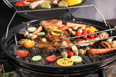 Photo of Cooking delicious meat and vegetables on barbecue grill, closeup