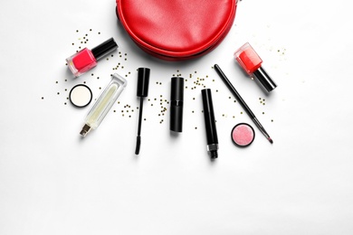 Makeup products with cosmetic bag on white background