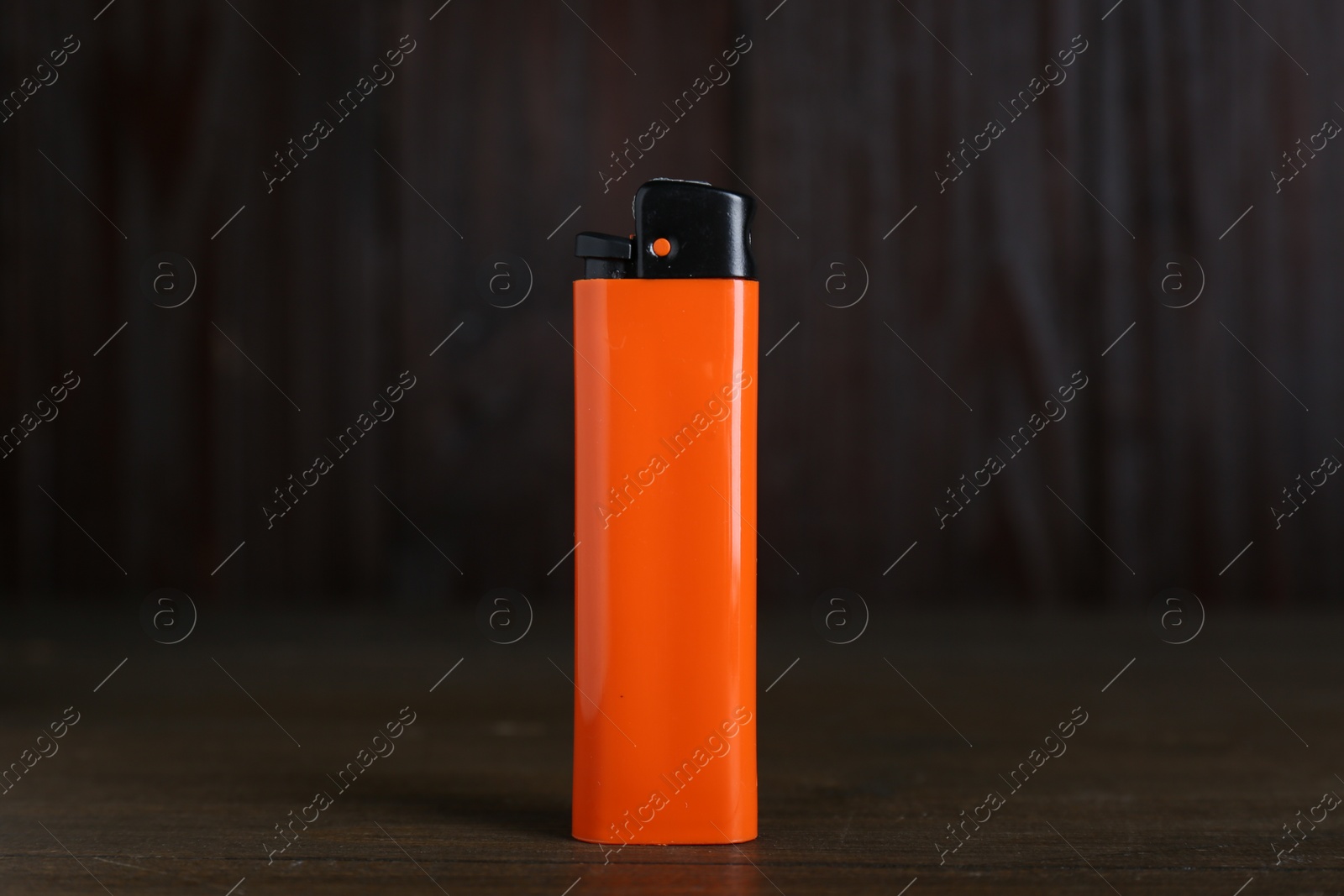 Photo of Stylish small pocket lighter on wooden table