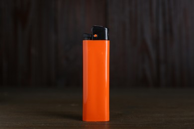 Photo of Stylish small pocket lighter on wooden table