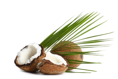 Photo of Fresh ripe brown coconuts with leaves on white background