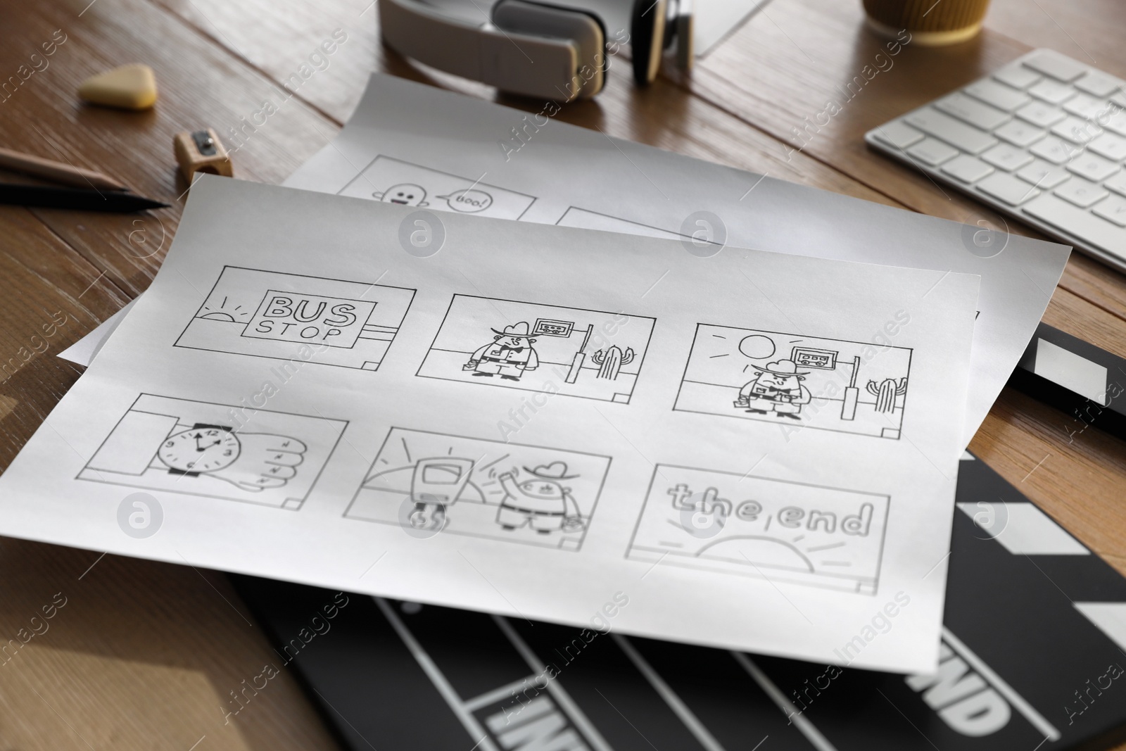 Photo of Storyboards with cartoon sketches at workplace, closeup. Pre-production process