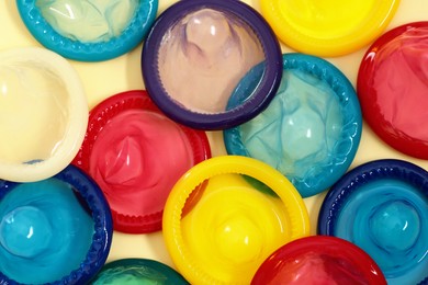 Condoms on beige background, top view. Safe sex