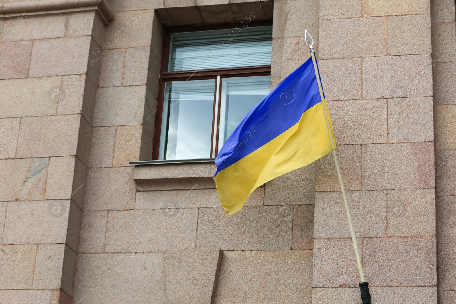 Photo of National flag of Ukraine on building facade