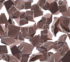 Delicious chocolate chunks falling on white background