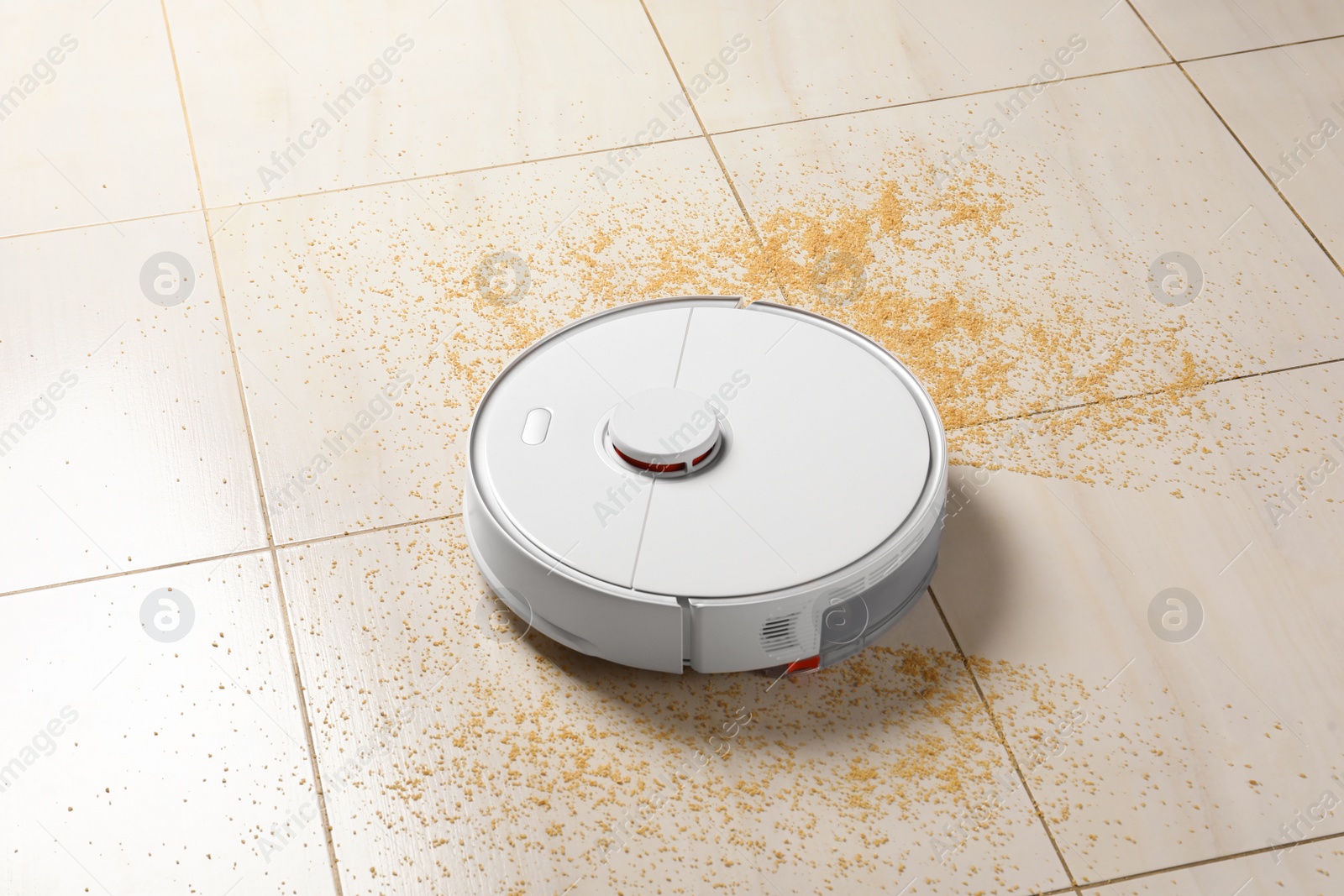 Photo of Robot vacuum cleaner removing dirt from floor in room