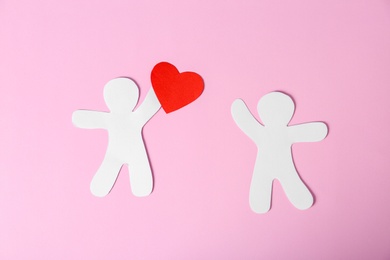 Paper people with red heart on color background. Romantic feelings