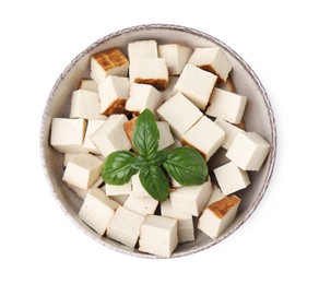 Bowl with delicious smoked tofu and basil on white background