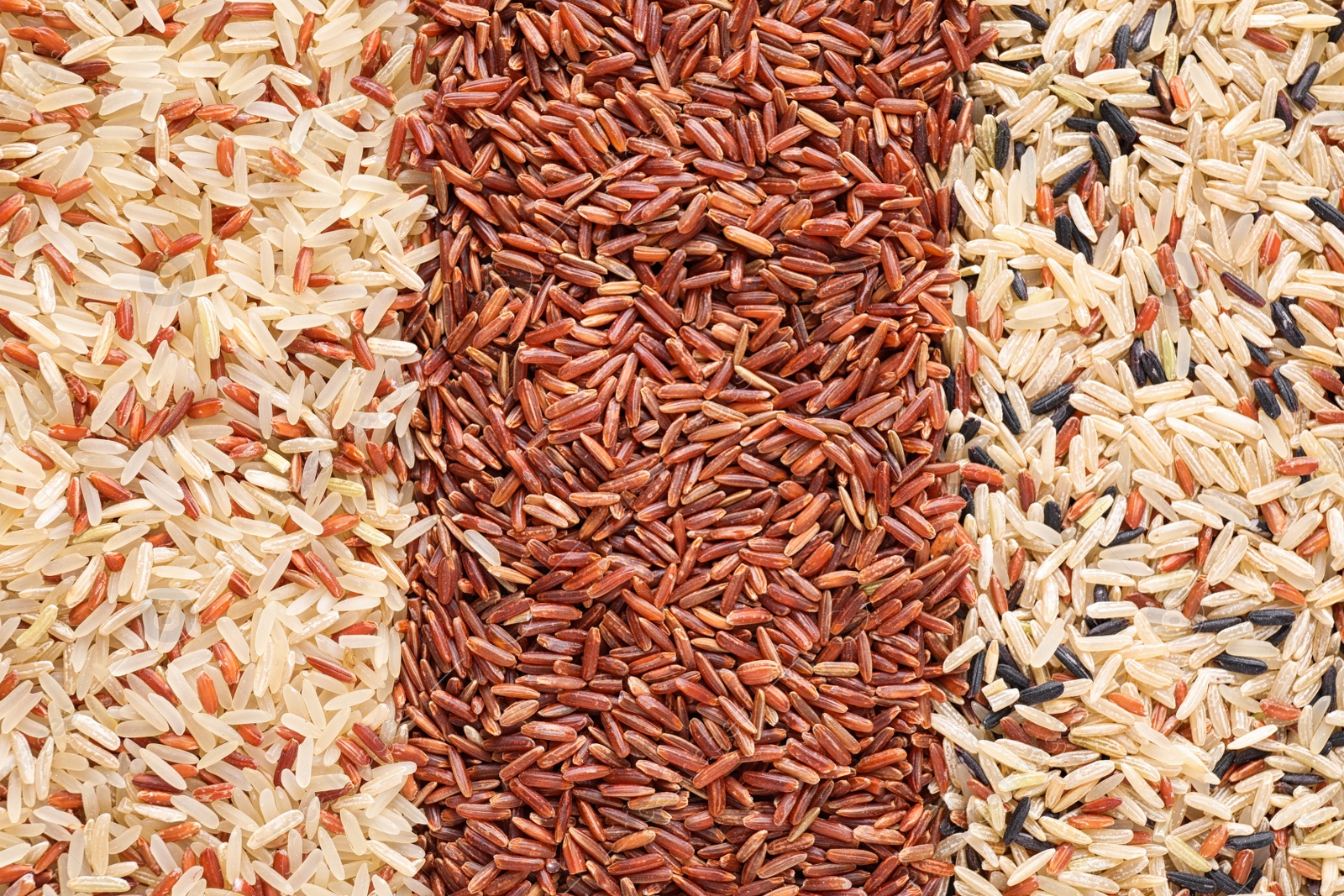 Photo of Mix of different brown rice as background, top view