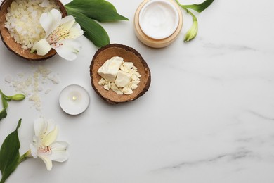 Photo of Flat lay composition with spa products and flowers on white marble table. Space for text