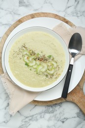 Delicious celery soup served on white marble table, top view