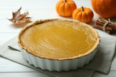 Delicious pumpkin pie on white wooden table, closeup
