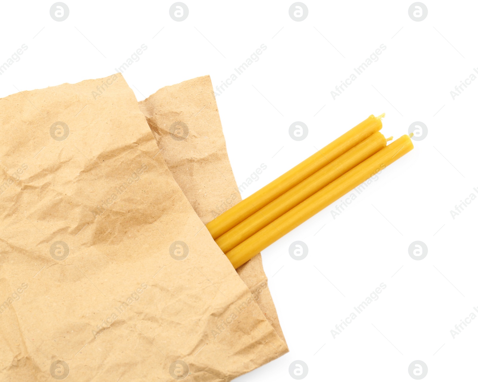 Photo of Parchment and church candles on white background, top view