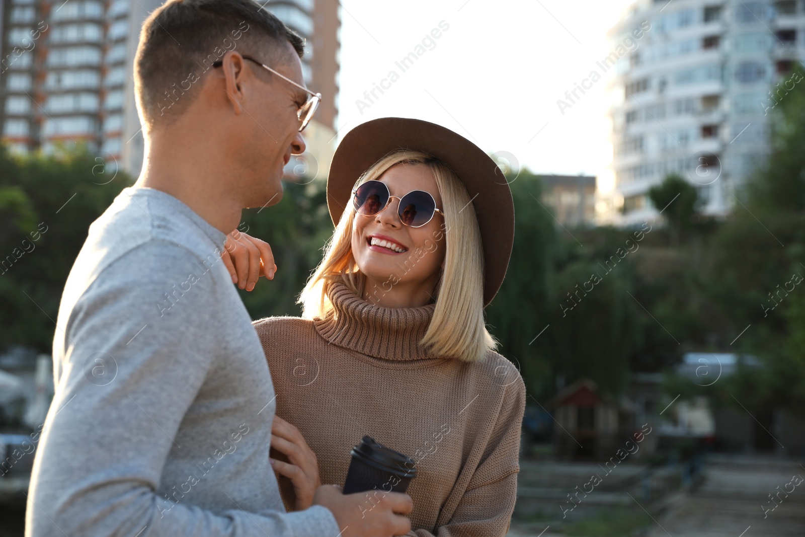 Photo of Couple in stylish sweaters on city street