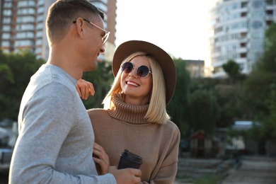 Couple in stylish sweaters on city street