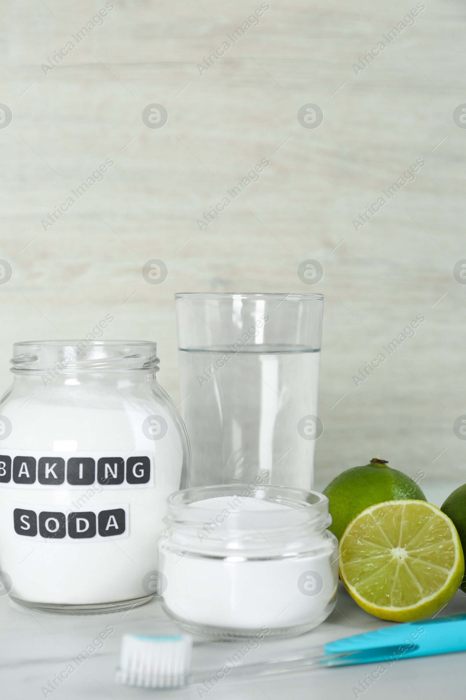 Photo of Composition with baking soda and toothbrush on white table