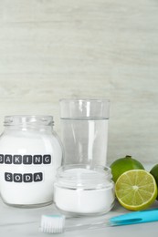 Composition with baking soda and toothbrush on white table