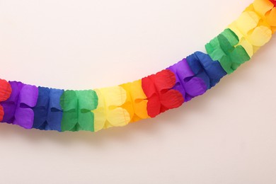 Photo of Rainbow paper garland on beige background. LGBT pride