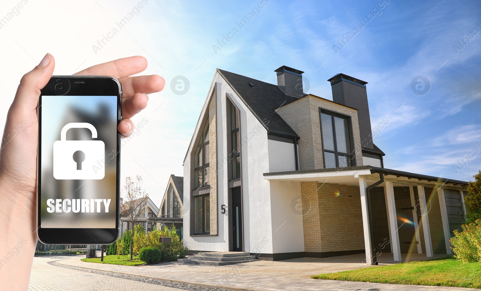 Image of Home security system. Woman with smartphone near her house outdoors, closeup