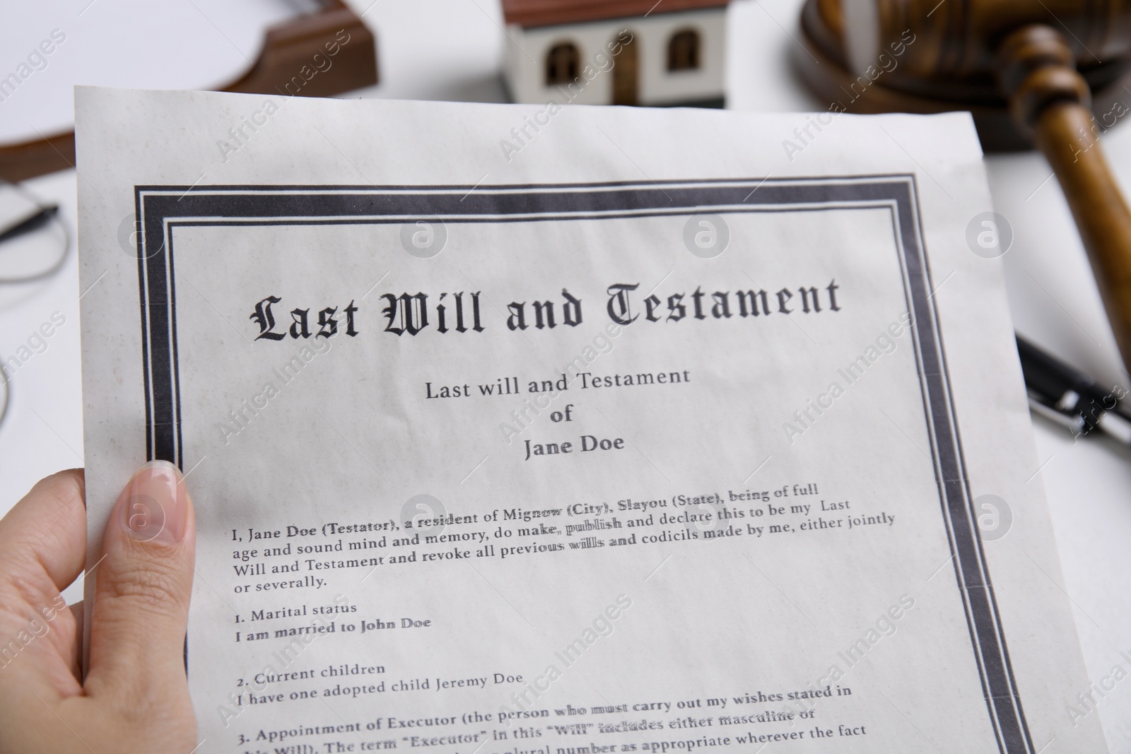 Photo of Woman holding last will and testament at table, closeup