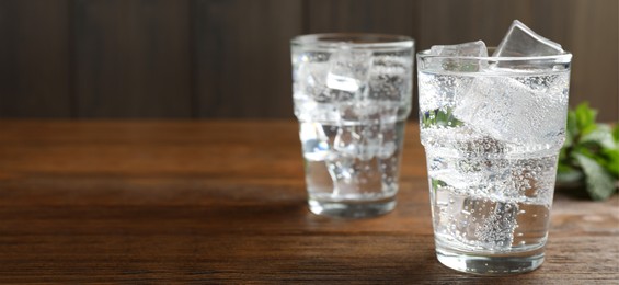 Refreshing soda water on wooden table. Banner design with space for text