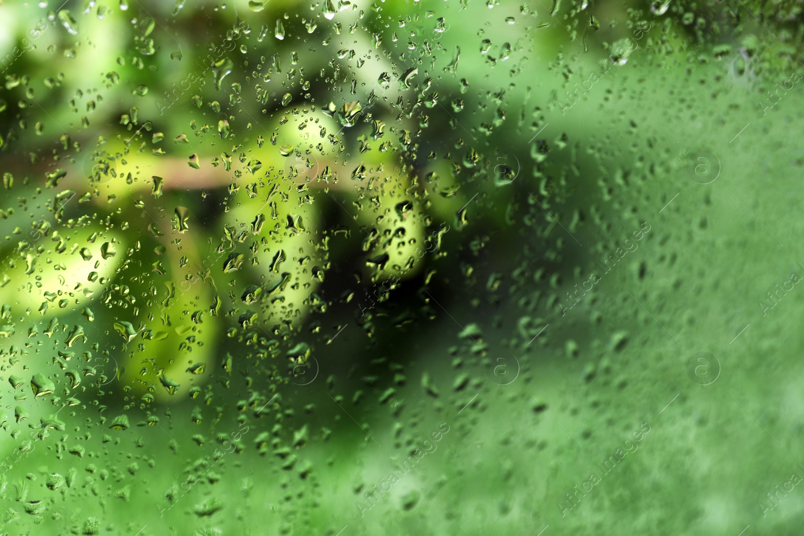 Photo of Window glass with rain drops as background, closeup