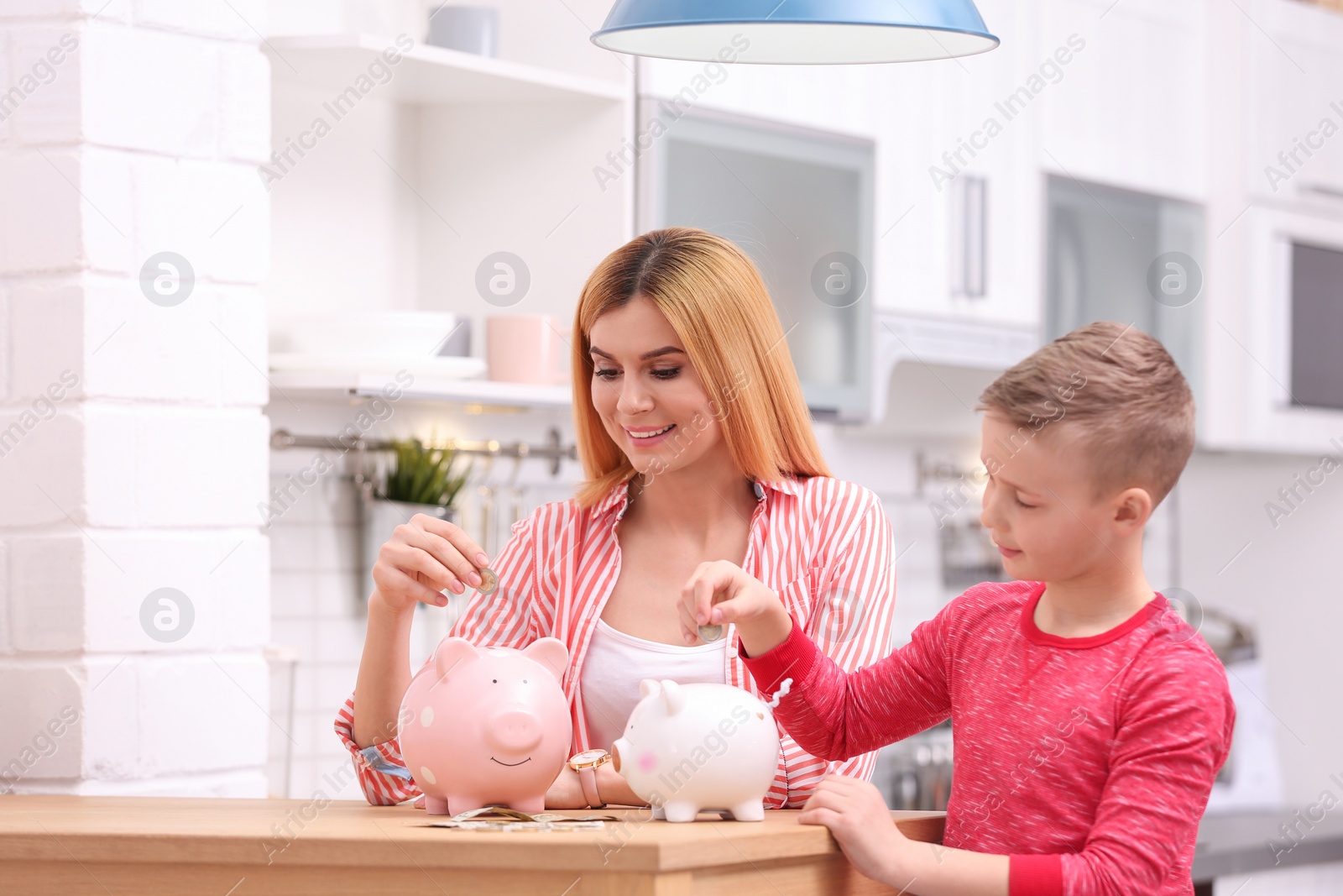 Photo of Family with piggy banks and money at home