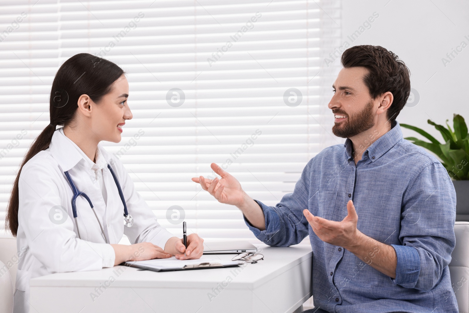 Photo of Doctor consulting patient during appointment in clinic