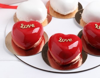 Photo of St. Valentine's Day. Delicious heart shaped cakes on white wooden table