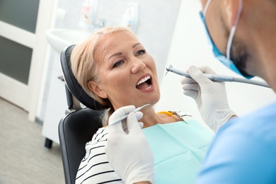 Professional dentist working with patient in clinic