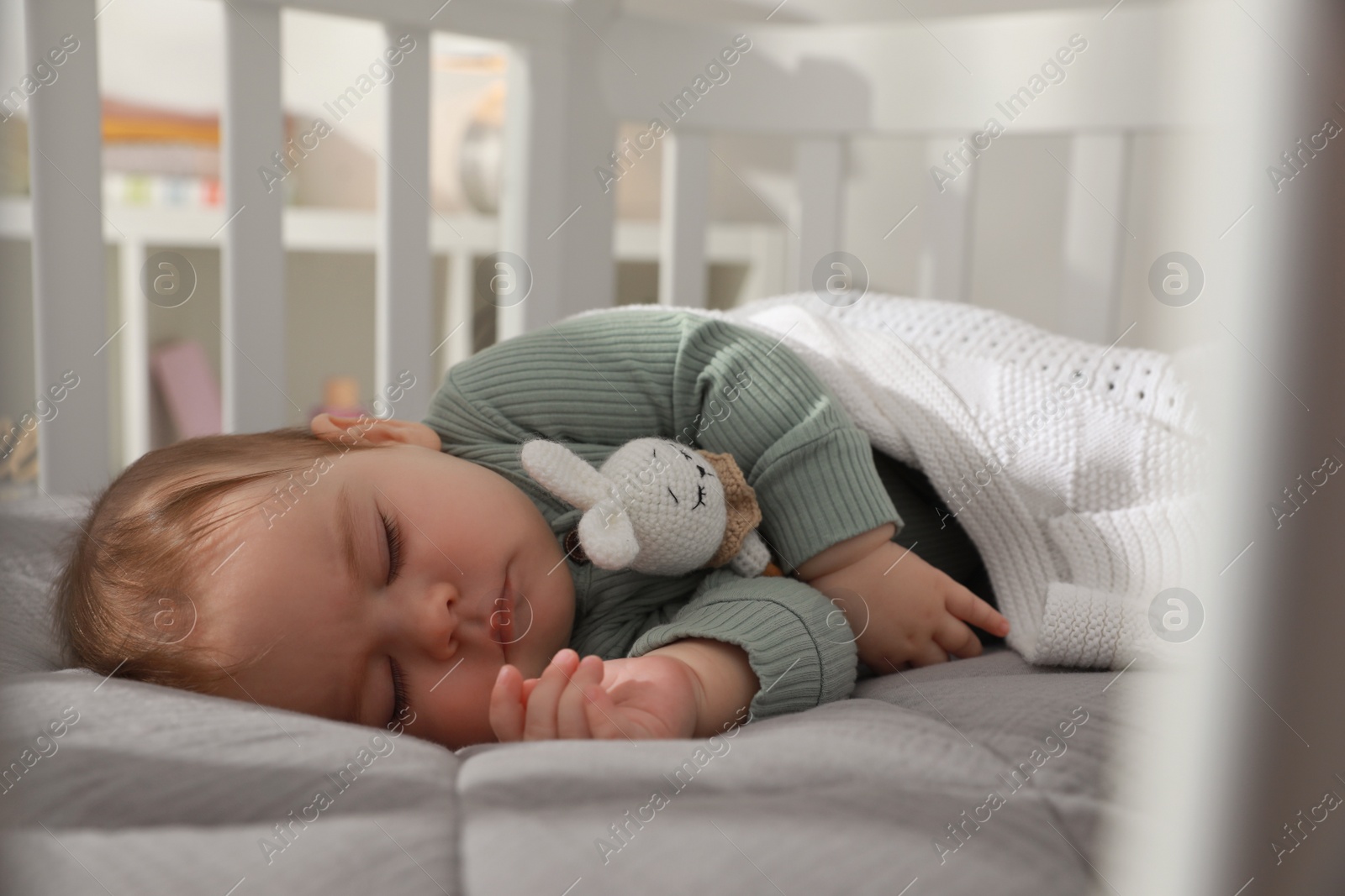 Photo of Cute little baby sleeping in crib at home. Bedtime