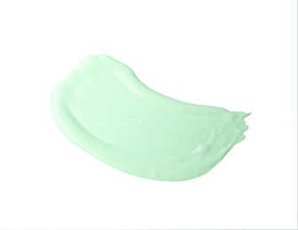 Photo of Stroke of green color correcting concealer isolated on white