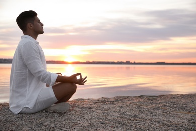 Photo of Man near river at sunset, space for text. Nature healing power