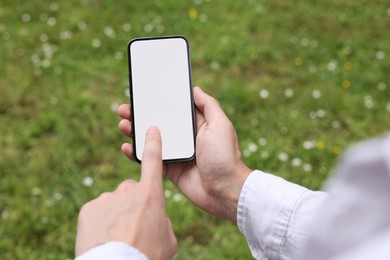 Photo of Man using mobile phone outdoors, closeup view