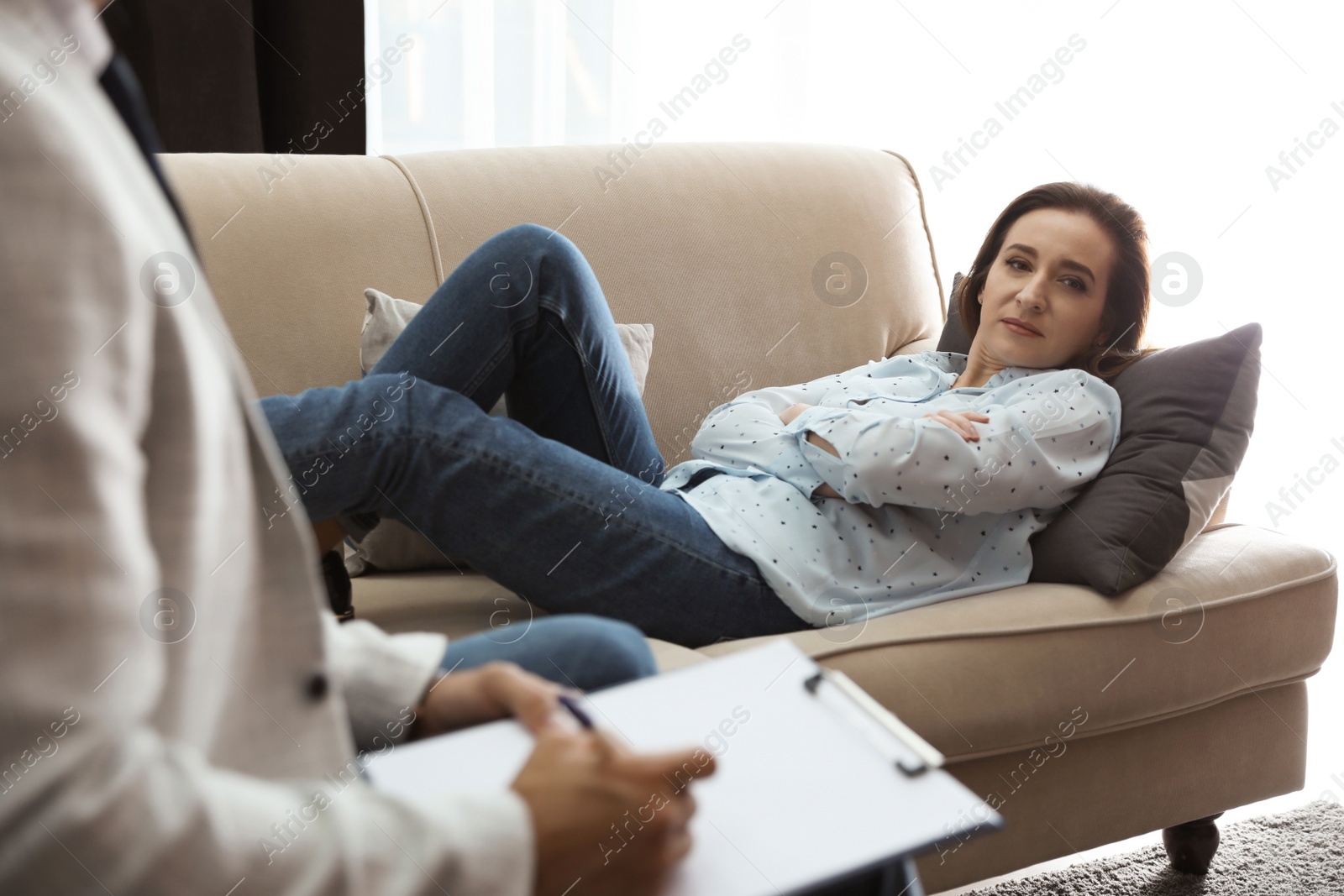 Photo of Professional psychotherapist working with patient in office