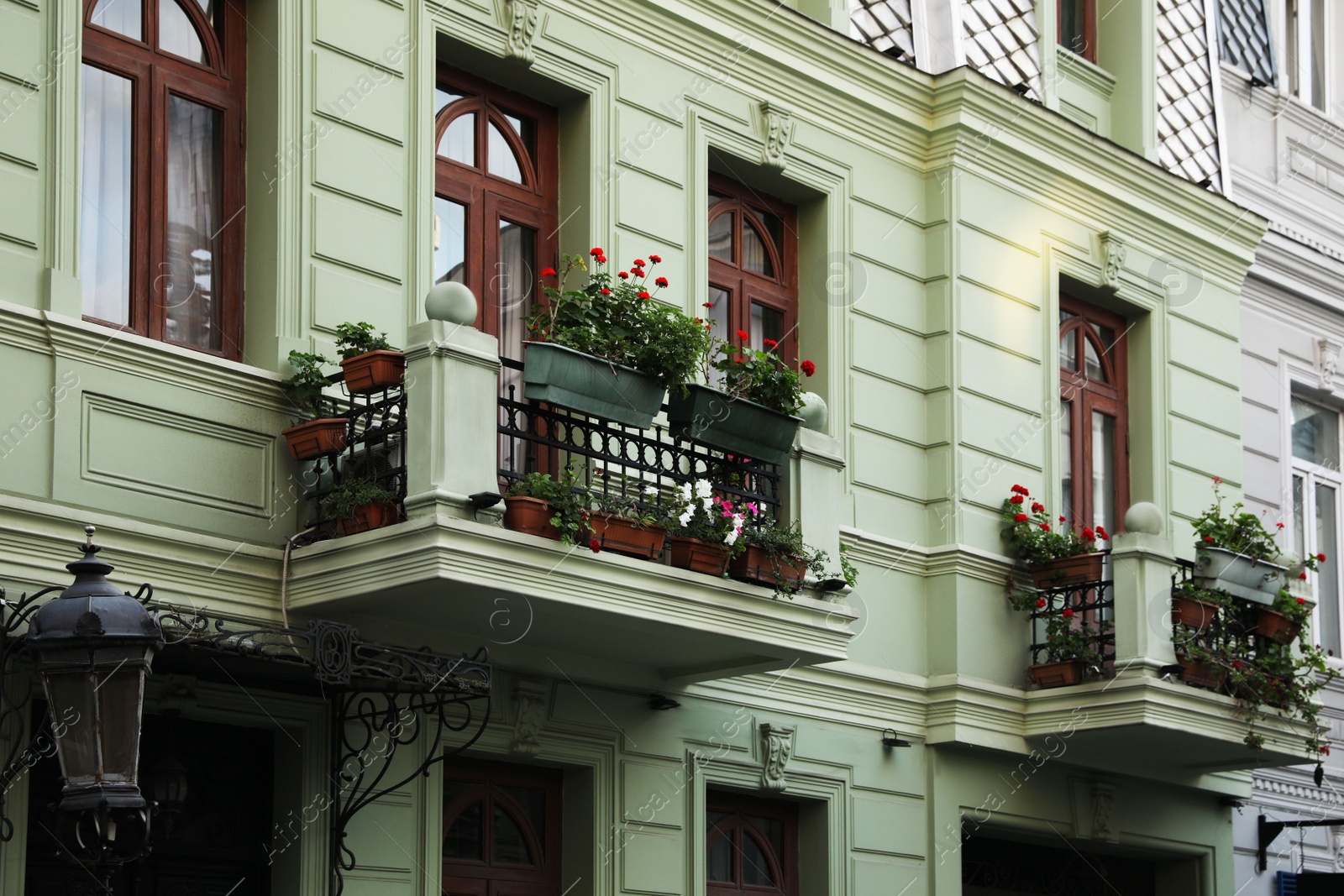 Photo of Exterior of beautiful residential building with flowers on balconies
