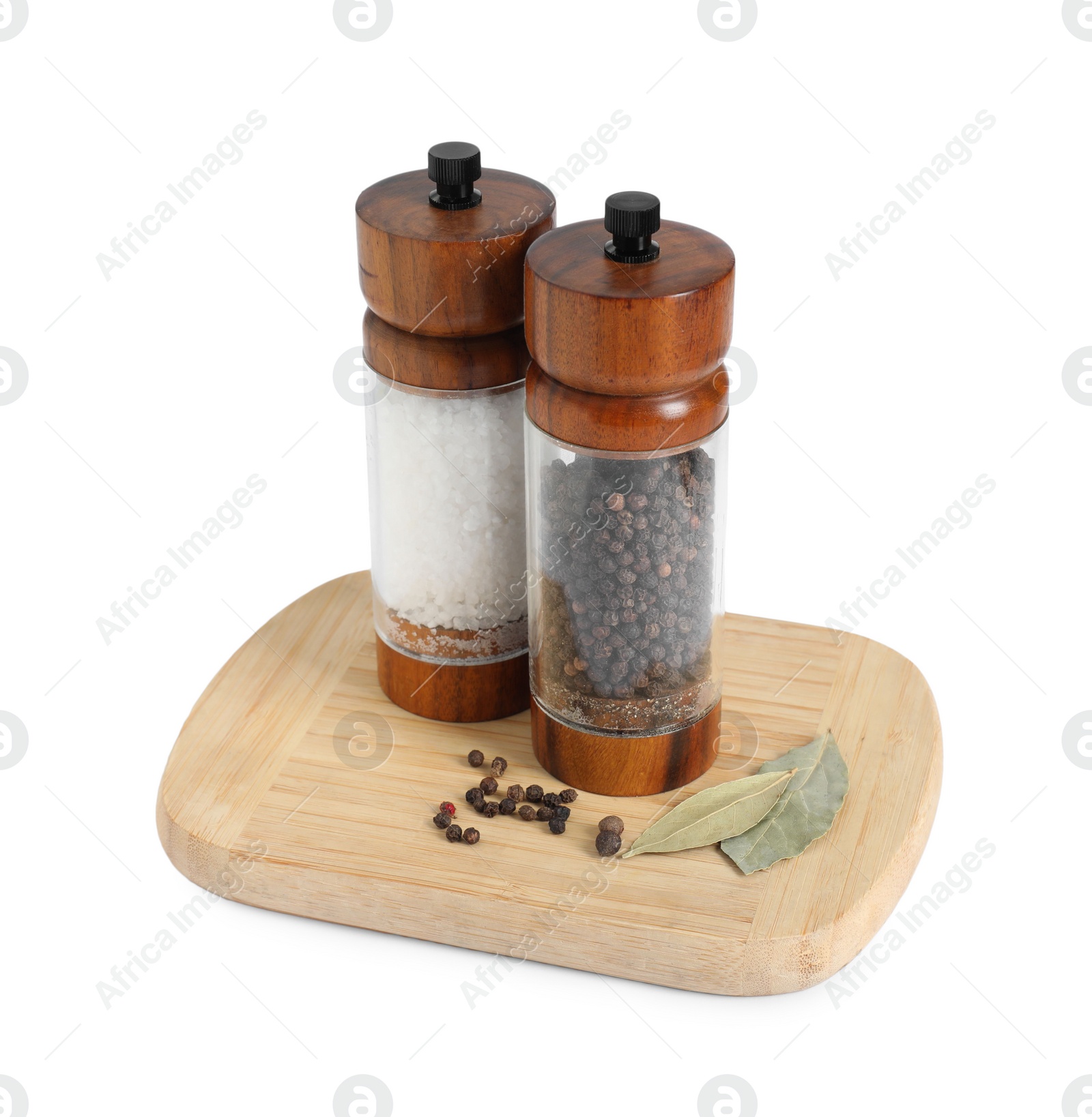 Photo of Salt and pepper shakers with bay leaves isolated on white