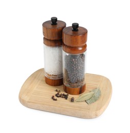 Photo of Salt and pepper shakers with bay leaves isolated on white