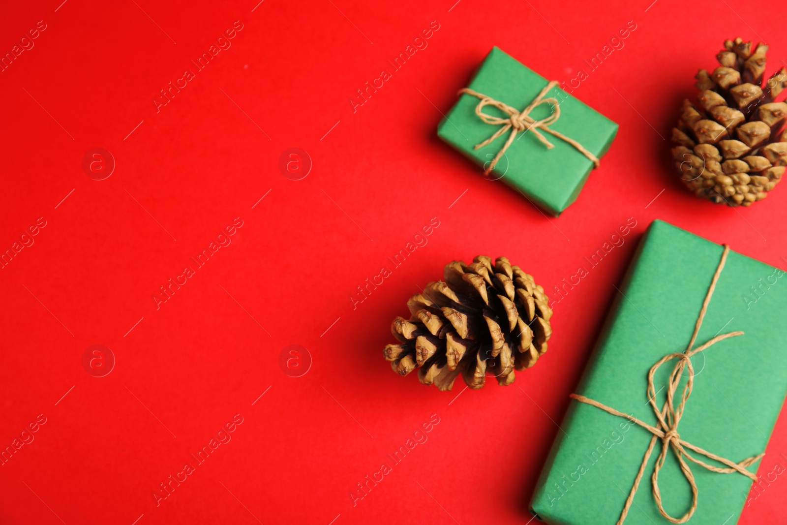 Photo of Flat lay composition with Christmas decor on red background. Space for text