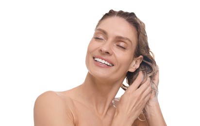 Beautiful happy woman washing hair on white background