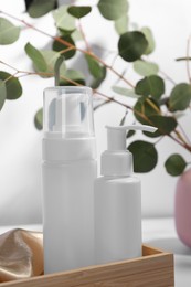 Bottles of face cleansing products in wooden holder, closeup