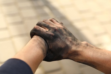 Photo of Dirty worker on blurred background, closeup of hands