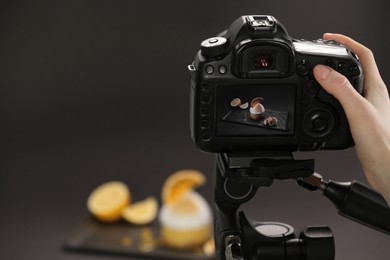 Food stylist taking photo of delicious dessert in studio, closeup. Space for text